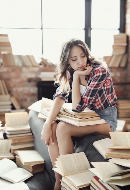 Young teenager girl reading a book at home