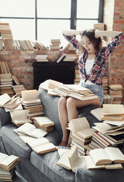 Young teenager girl reading a book at home