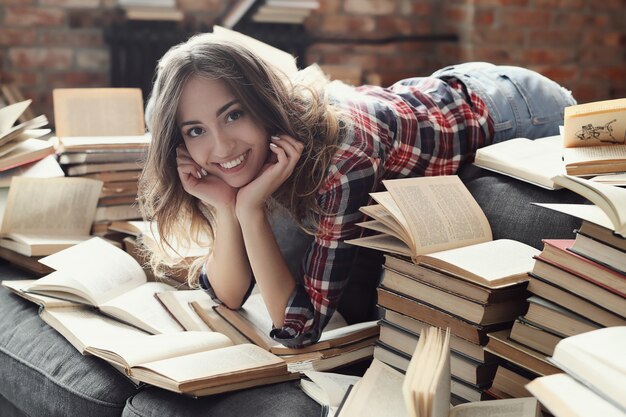 Young teenager girl reading a book at home