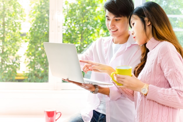 Young teenagers working with laptop together