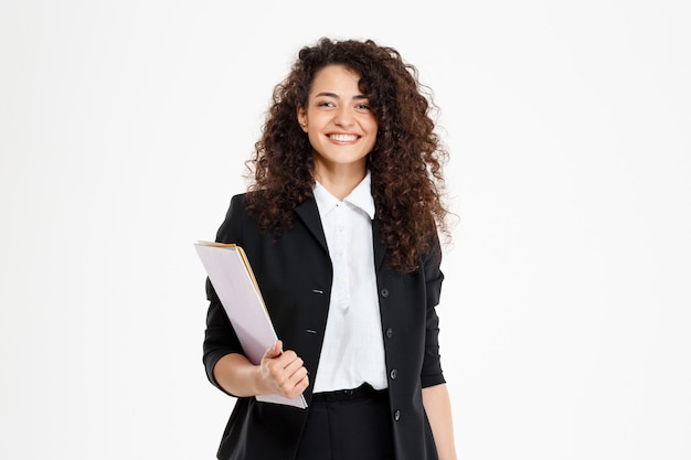 Young tender curly girl holding documents