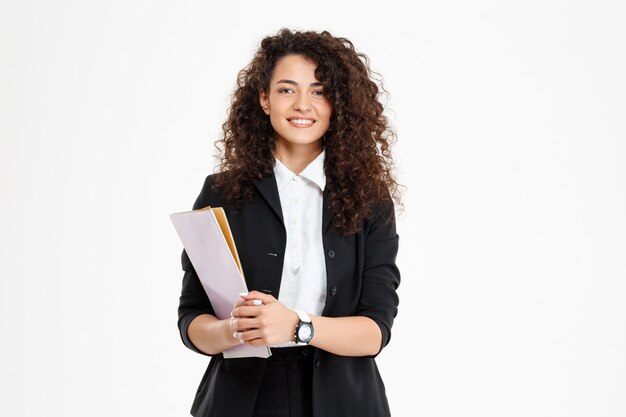 Young tender curly girl holding documents