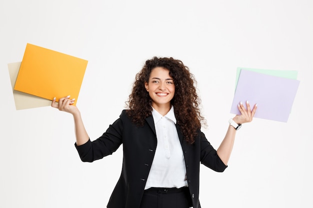 Young tender curly girl holding documents