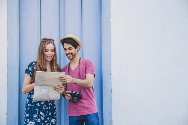 Free photo young tourist couple with map