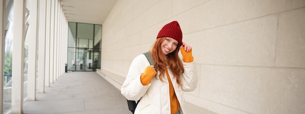 Free photo young tourist happy girl walking around european city with backpack student goes to university goes