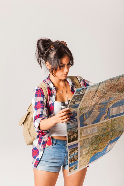 Young tourist woman looking at map