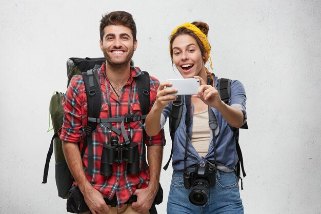 Free photo young tourists couple with equipment