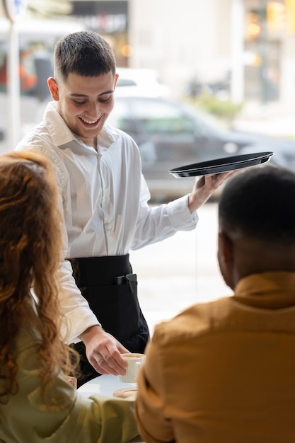 Young trans man working as a waiter