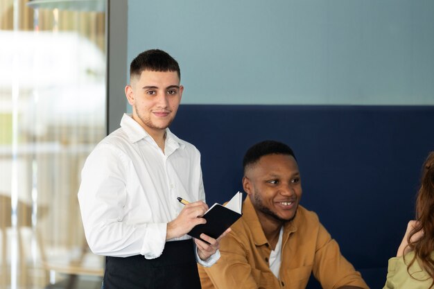 Young trans man working as a waiter