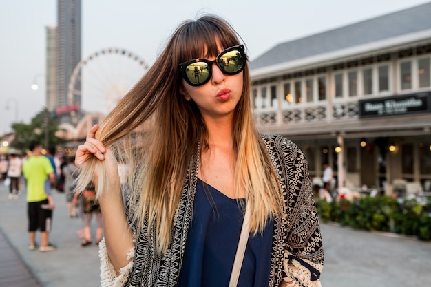 Free photo young travel woman send kiss , having great time  on riverfront of bangkok