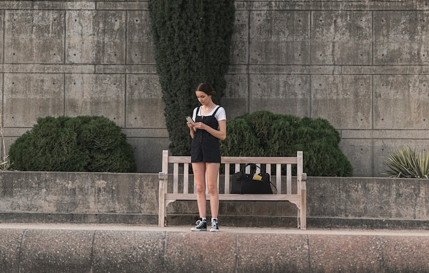 Young traveler checking her phone on vacation