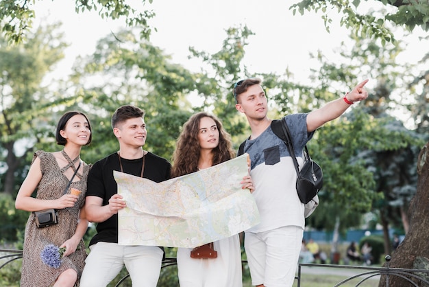 Young travelers exploring park with map