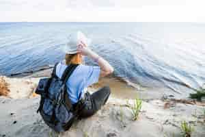 Free photo young traveller looking at sea