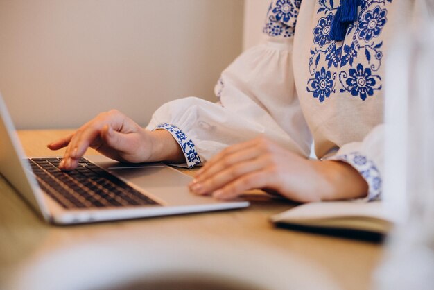 Young ukrainian woman wearing vyshyvanka working from home