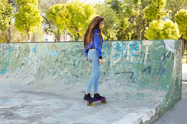 Young urban woman skating