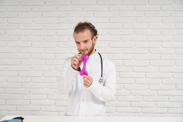 Young vet with stethoscope holding bone in arms