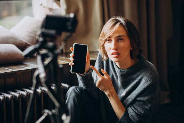 Young video blogger making a video review for her vlog