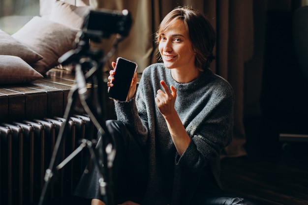 Young video blogger making a video review for her vlog