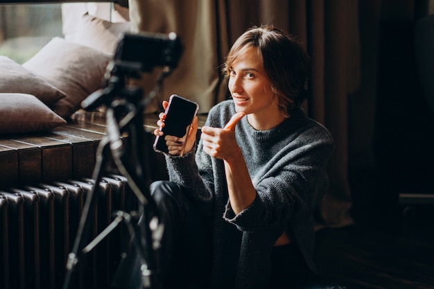 Young video blogger making a video review for her vlog