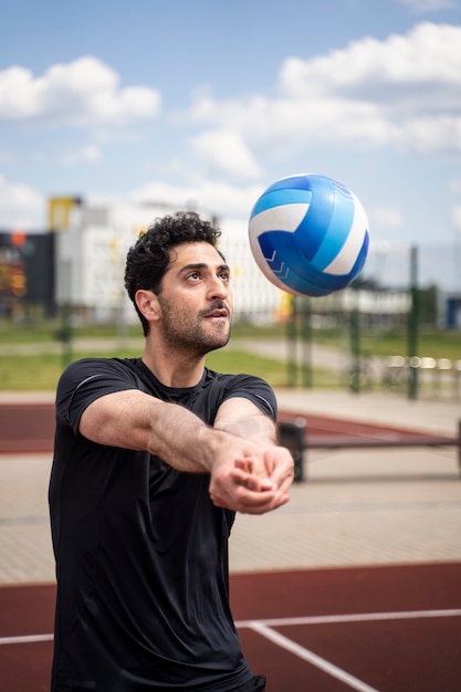Young volleyball man player in the court
