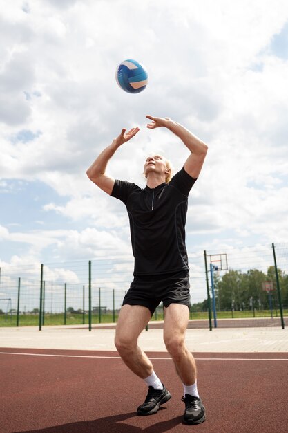 Young volleyball man player in the court