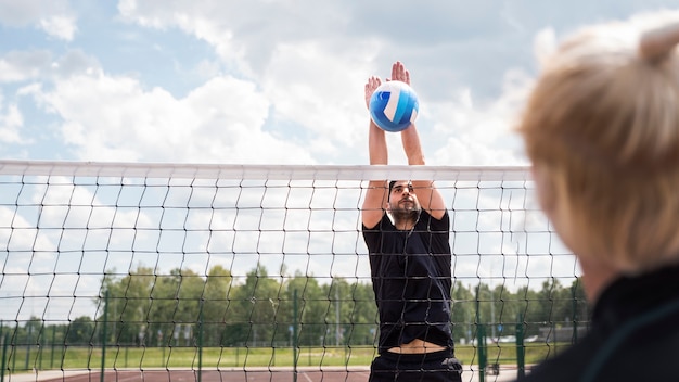 Young volleyball man player in the court