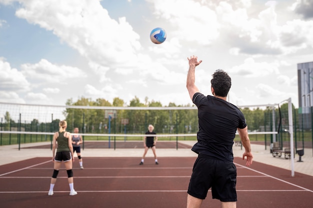 Free photo young volleyball man player in the court