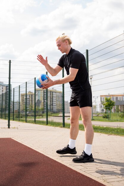 Young volleyball man player in the court