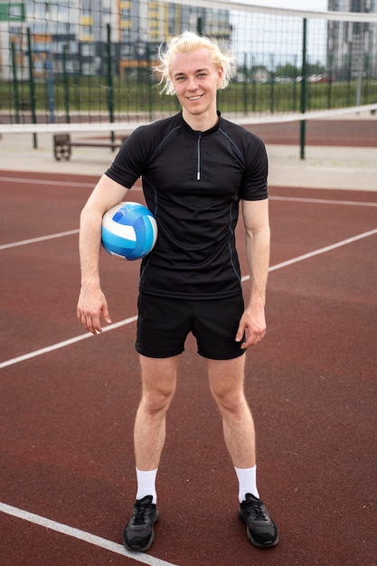 Free photo young volleyball man player in the court