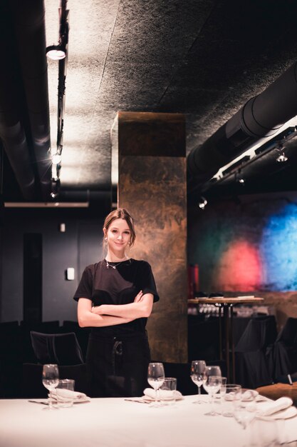 Young waitress near banquet table