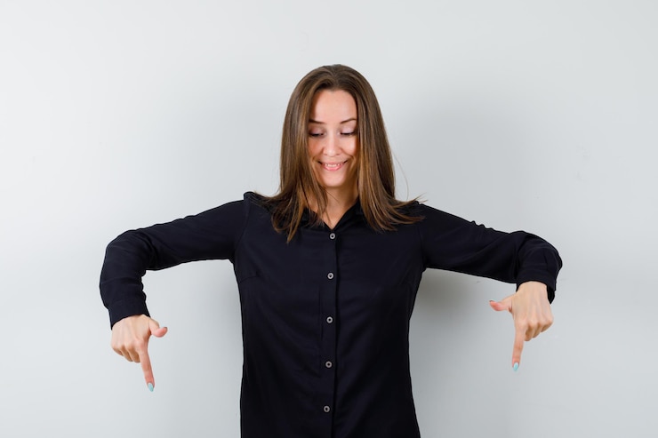 Free Photo young woma pointing down with index fingers