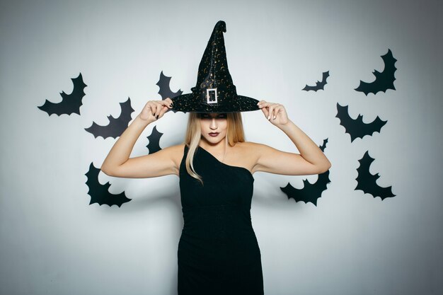 Young woman adjusting Halloween hat