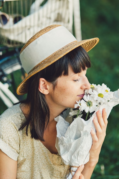 Young woman against nature background with bike