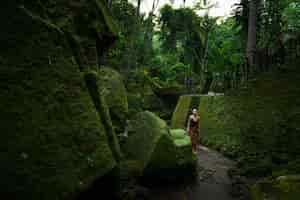 Free photo young woman among temple ruins