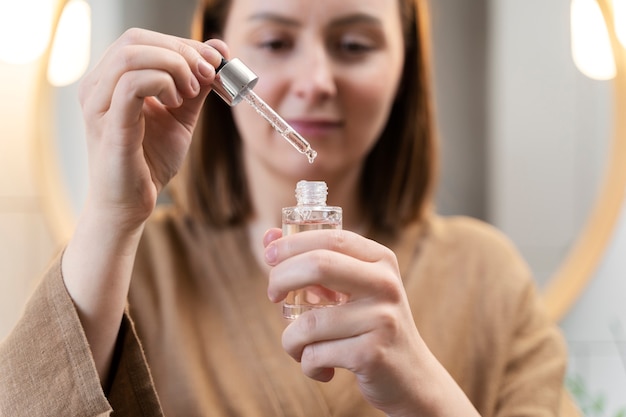 Free photo young woman applying anti dandruff product