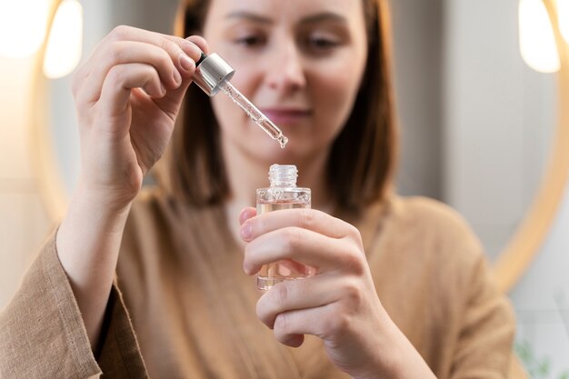 Young woman applying anti dandruff product