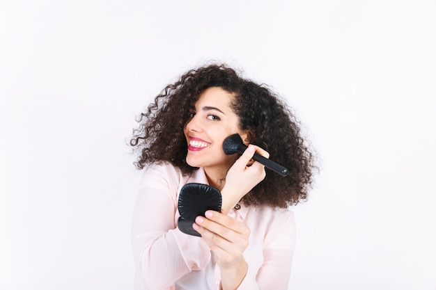 Young woman applying makeup