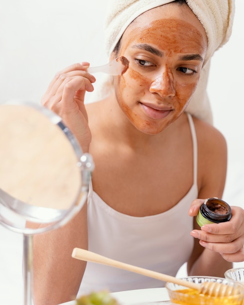 Young woman applying a natural face mask
