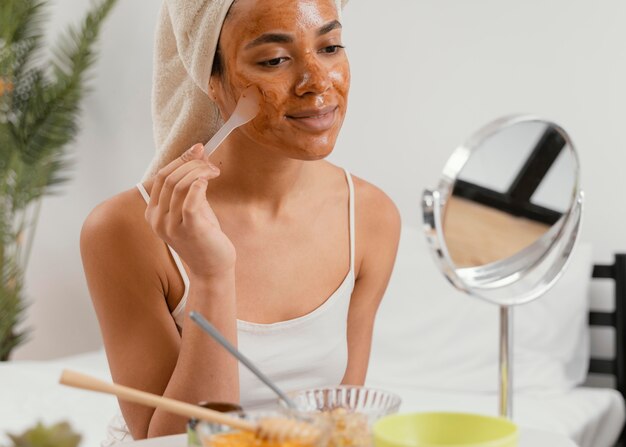 Young woman applying a natural face mask