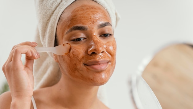 Young woman applying a natural face mask