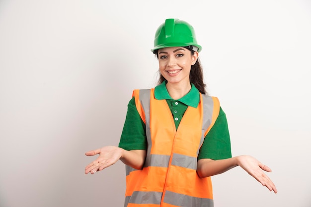 Free photo young woman architect in uniform and helmet. high quality photo