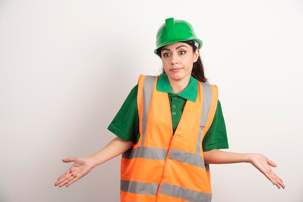 Young woman architect in uniform and helmet. High quality photo