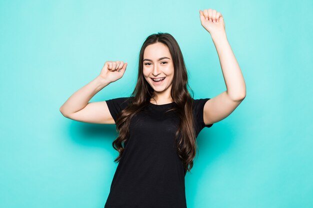 Young woman arm hand palm fists raised up air gladness yelling loudly great achievement successful isolated turquoise wall