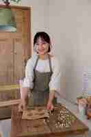 Free photo young woman arranging her cake shop