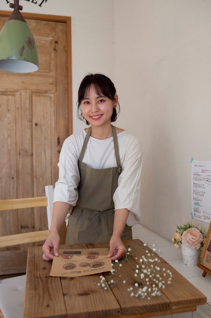 Young woman arranging her cake shop