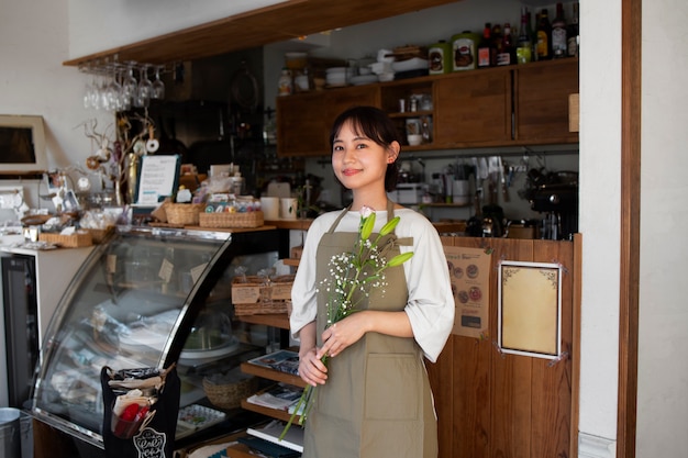 Young woman arranging her cake shop