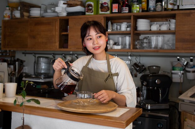 Young woman arranging her cake shop