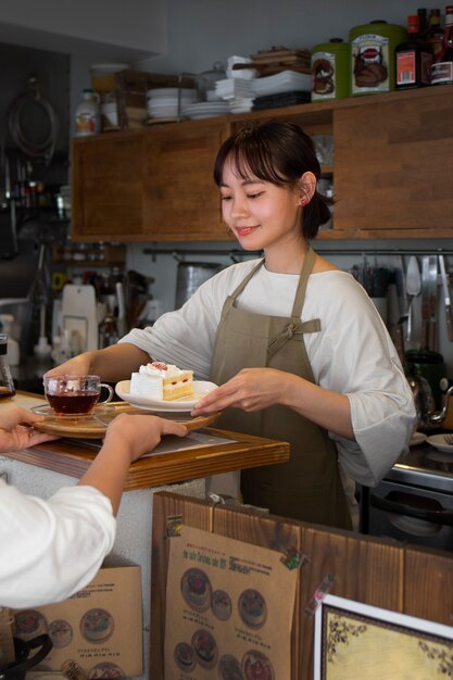 Young woman arranging her cake shop