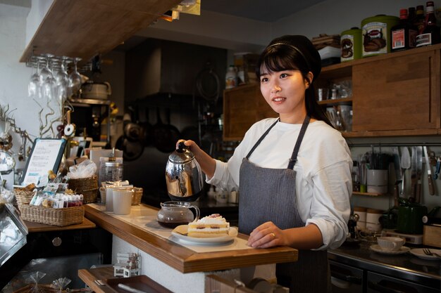 Young woman arranging her cake shop