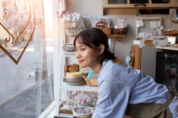 Young woman arranging her cake shop